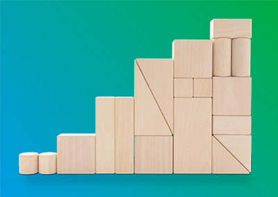 Stacked wooden blocks of different shapes and sizes.